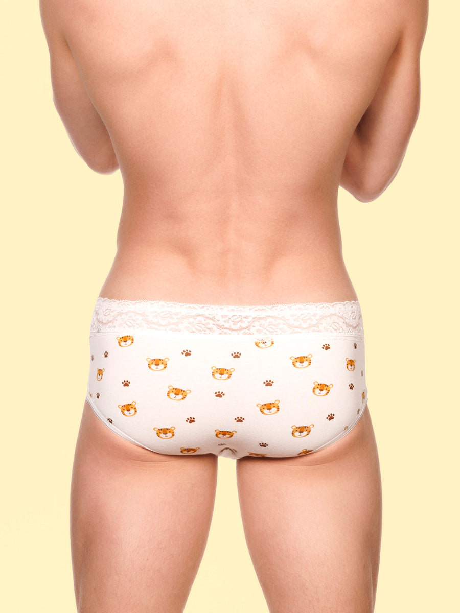 Back view of a man wearing white XDress panties with lace trim and tiger pattern against a yellow background