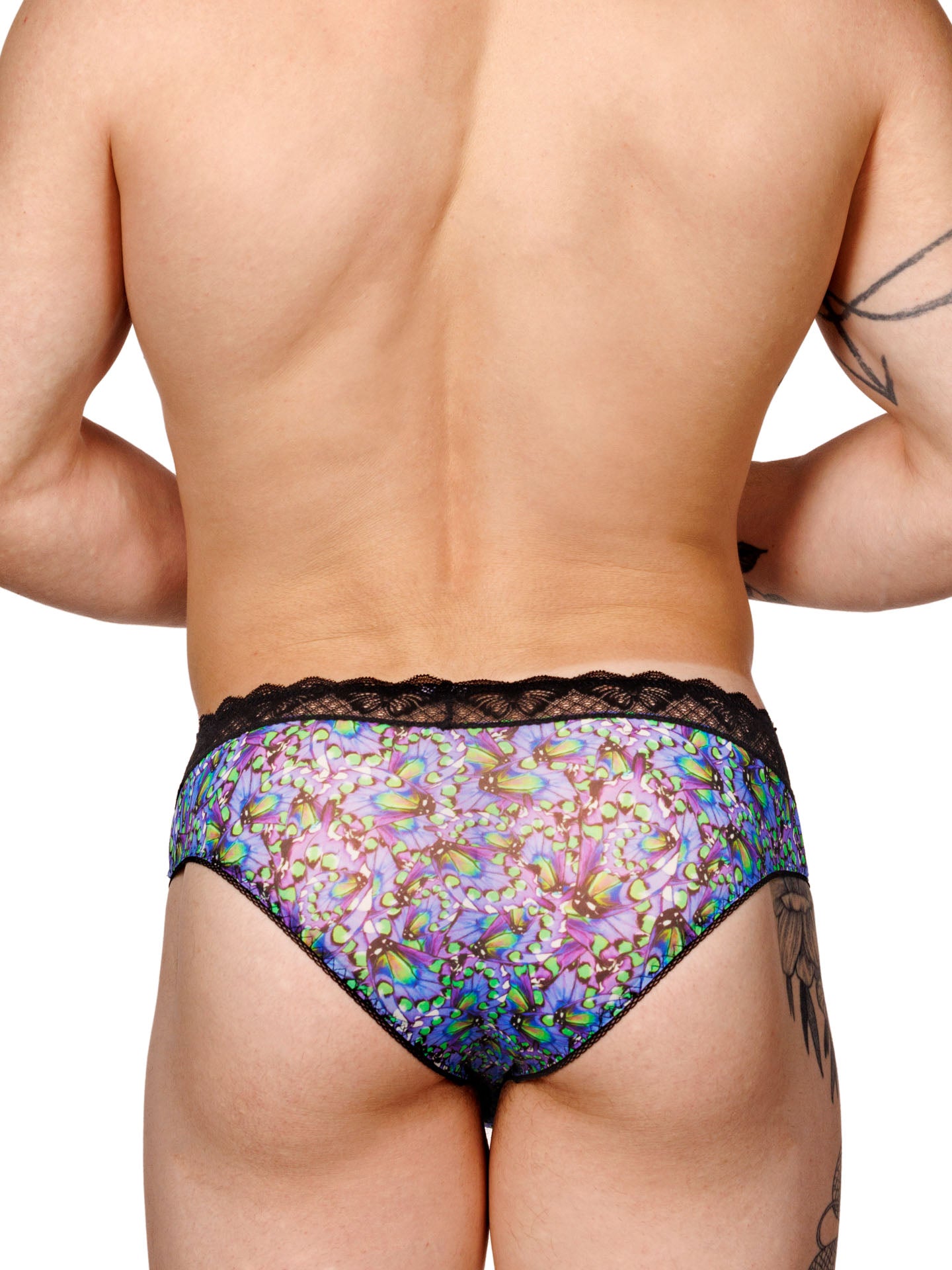 Male model wearing a blue floral print XDress men's panty with a black lace waistband, shown from the back.