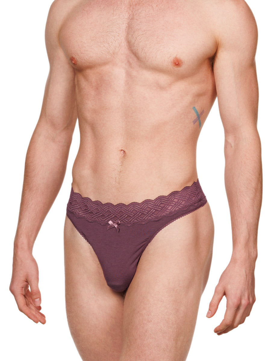 Side view of a male model wearing a burgundy red XDress cotton thong with a matching lace waistband