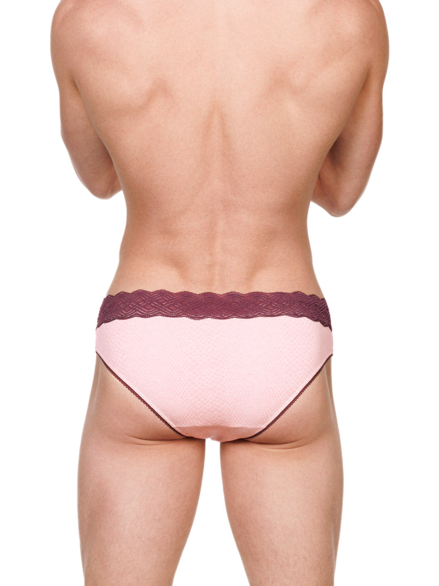 Back view of a male model wearing pink XDress cotton panties with a red lace waistband