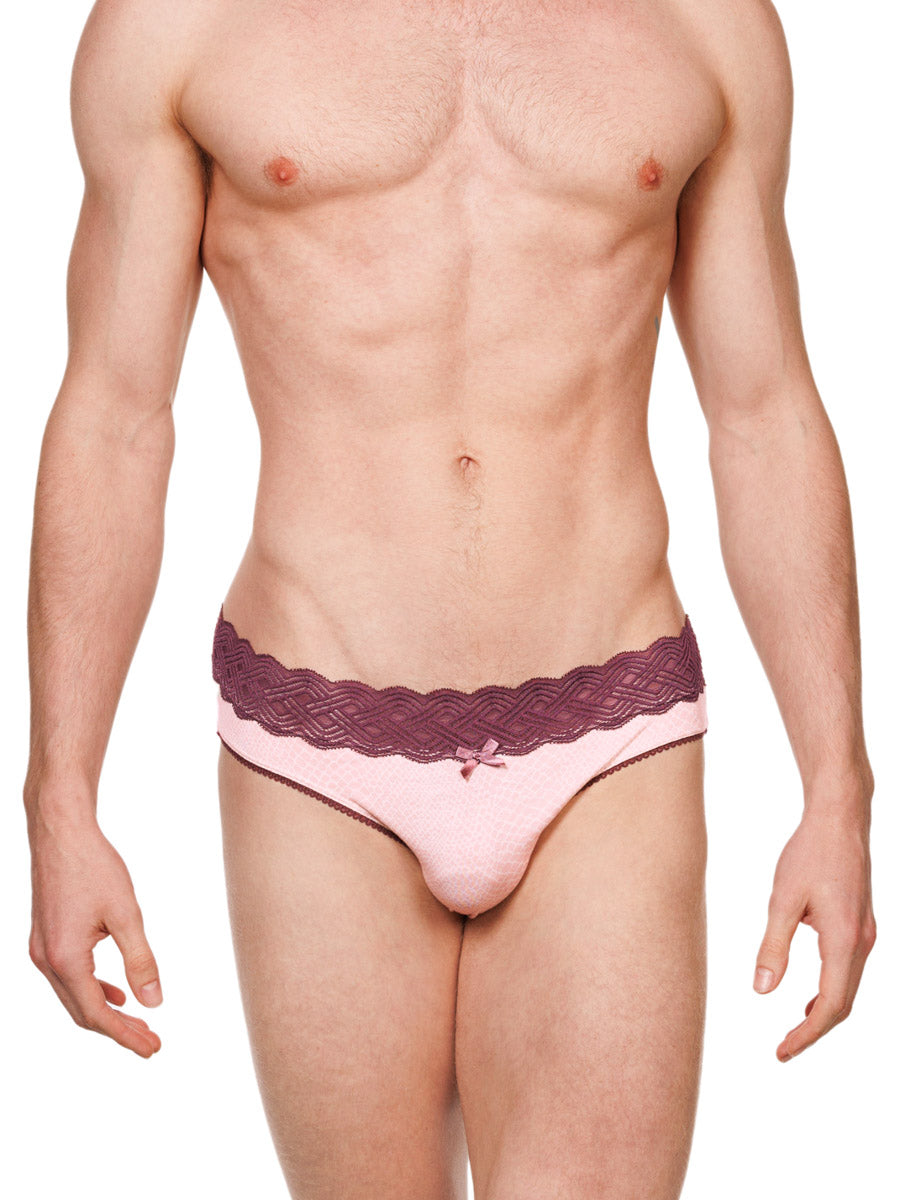 Front view of a male model wearing pink XDress cotton panties with a red lace waistband