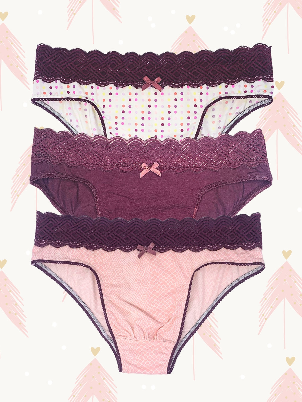 3-pack of men's panties with a lace waistband and satin bow detail. Includes polka dot, light pink, and solid burgundy designs