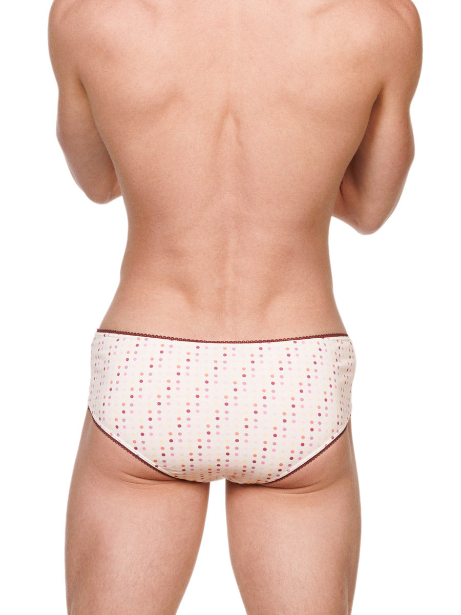 Back view of a male model wearing white XDress cotton panties with a polka dot pattern