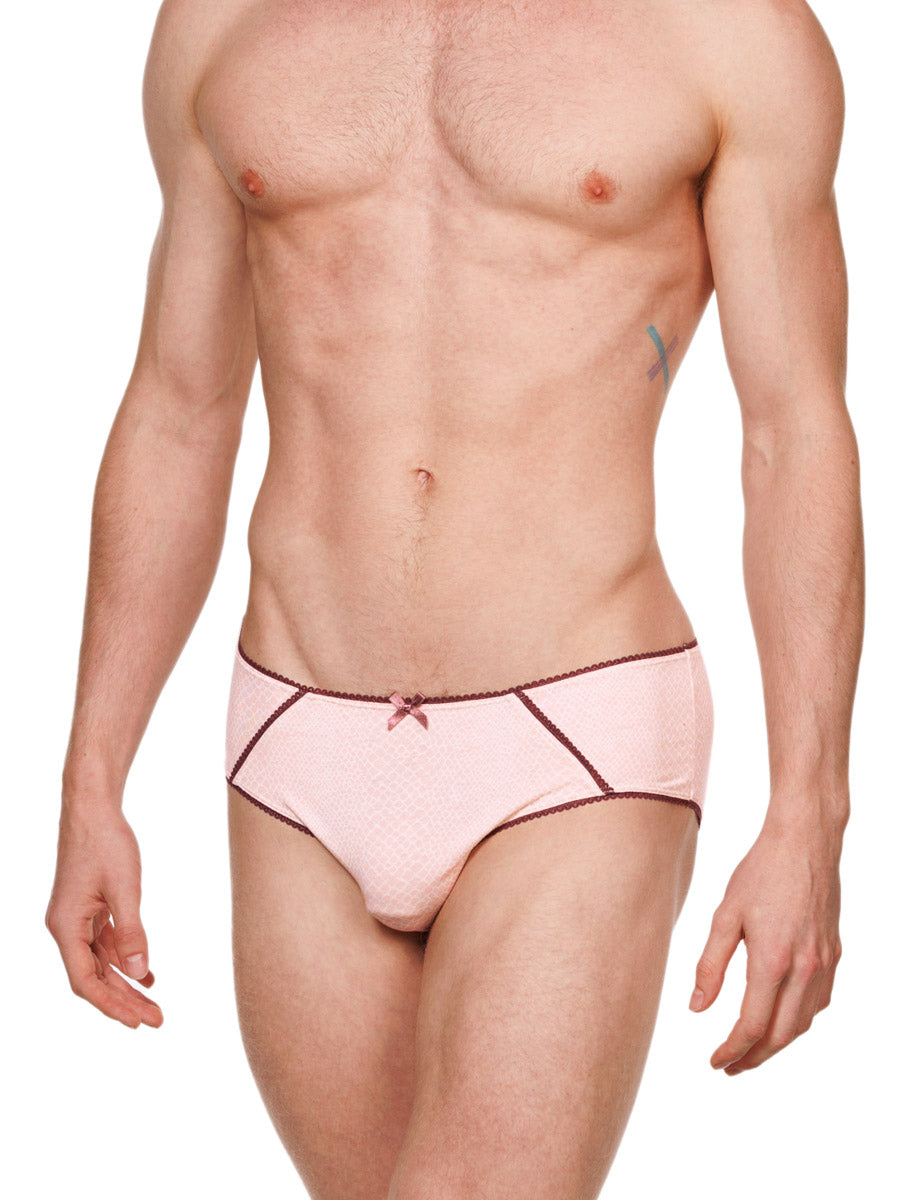 Side view of a male model wearing pink cotton XDress panties with red lace