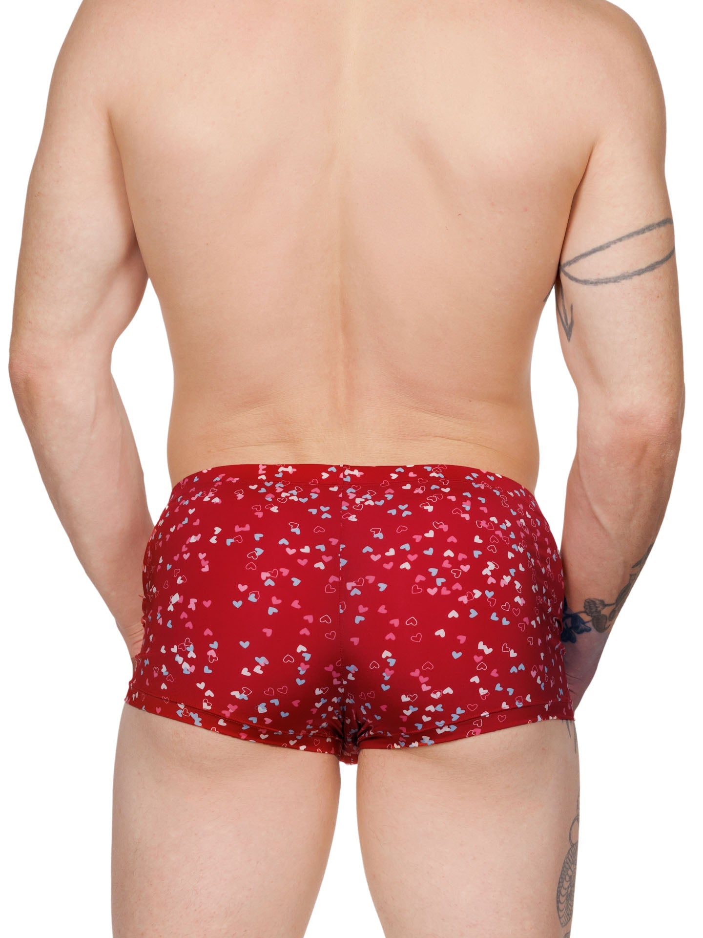 Back view of a male model wearing red XDress boxer shorts with a multicolor heart pattern