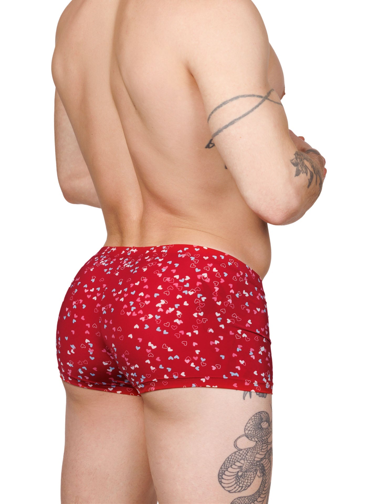 Back view of a male model wearing red XDress boxer shorts with a multicolor heart pattern