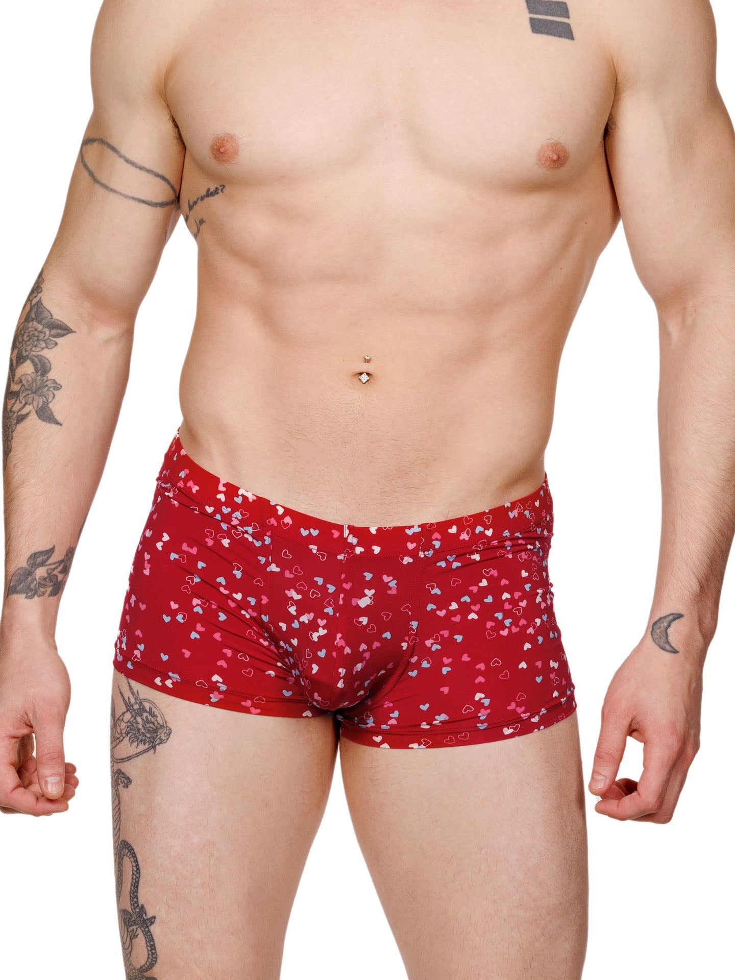 Front view of a male model wearing red XDress boxer shorts with a multicolor heart pattern