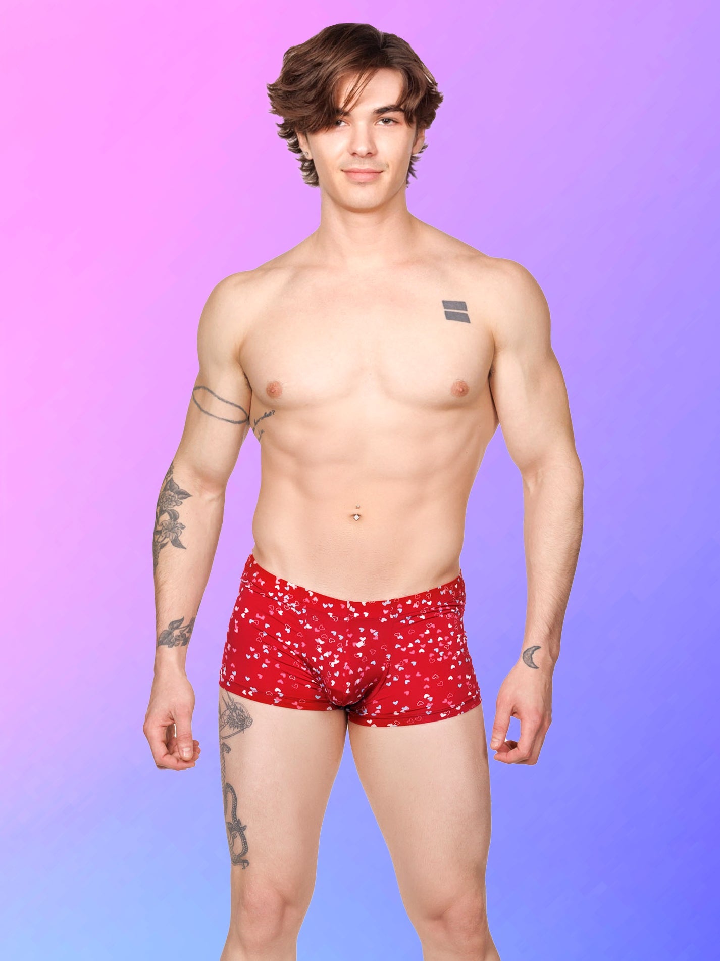 Front view of a male model wearing red XDress boxer shorts with a multicolor heart pattern