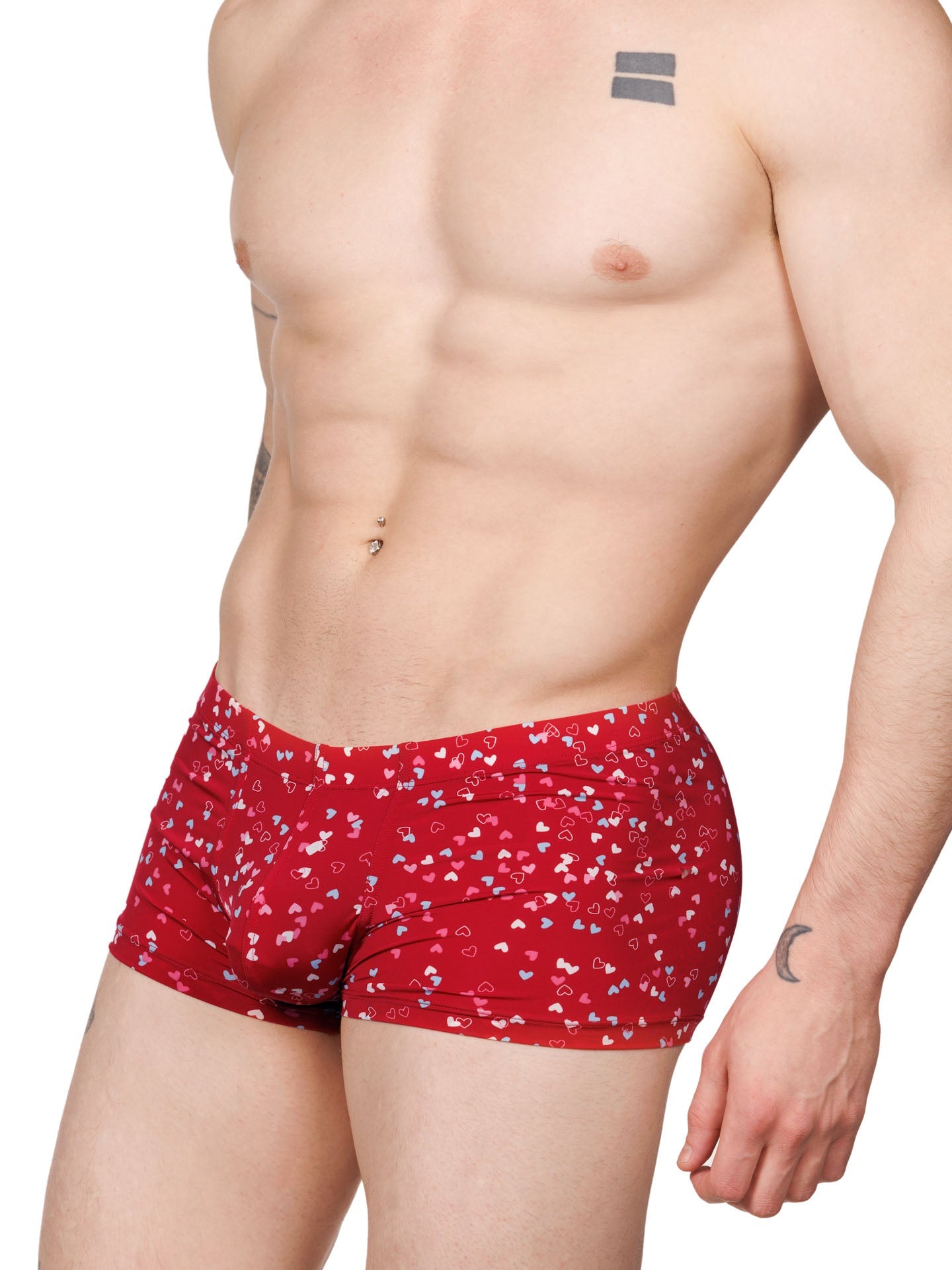 Side view of a male model wearing red XDress boxer shorts with a multicolor heart pattern