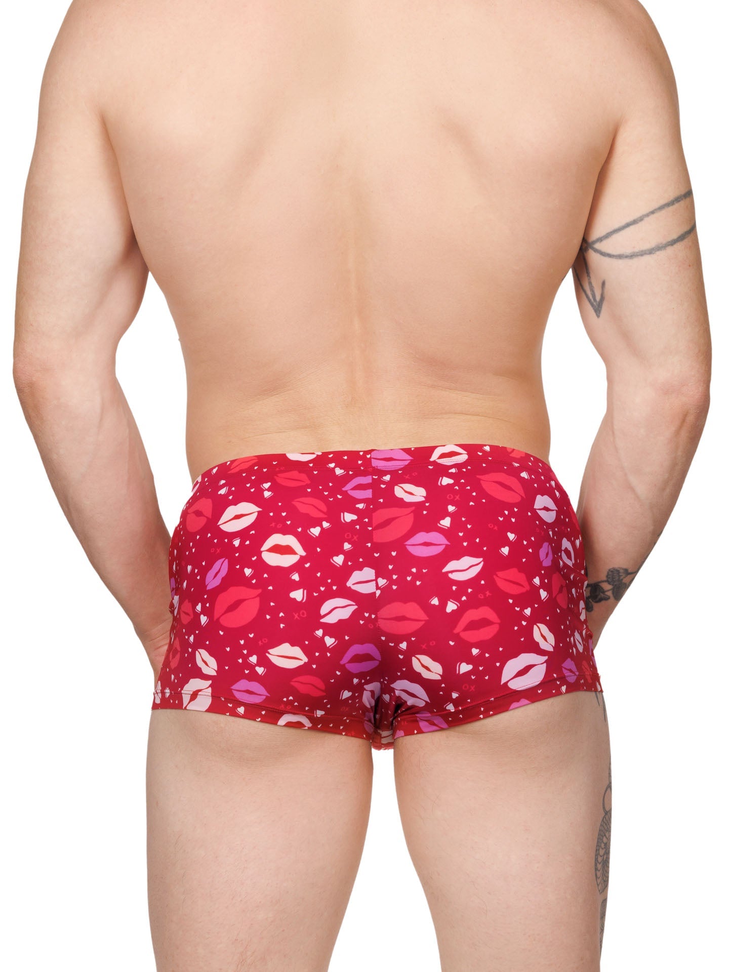 Back view of a male model wearing red XDress boxer shorts with a lipstick kiss pattern