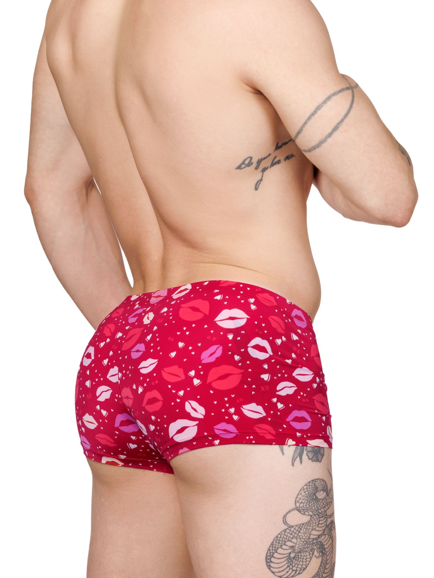 Side view of a male model wearing red XDress boxer shorts with a lipstick kiss pattern