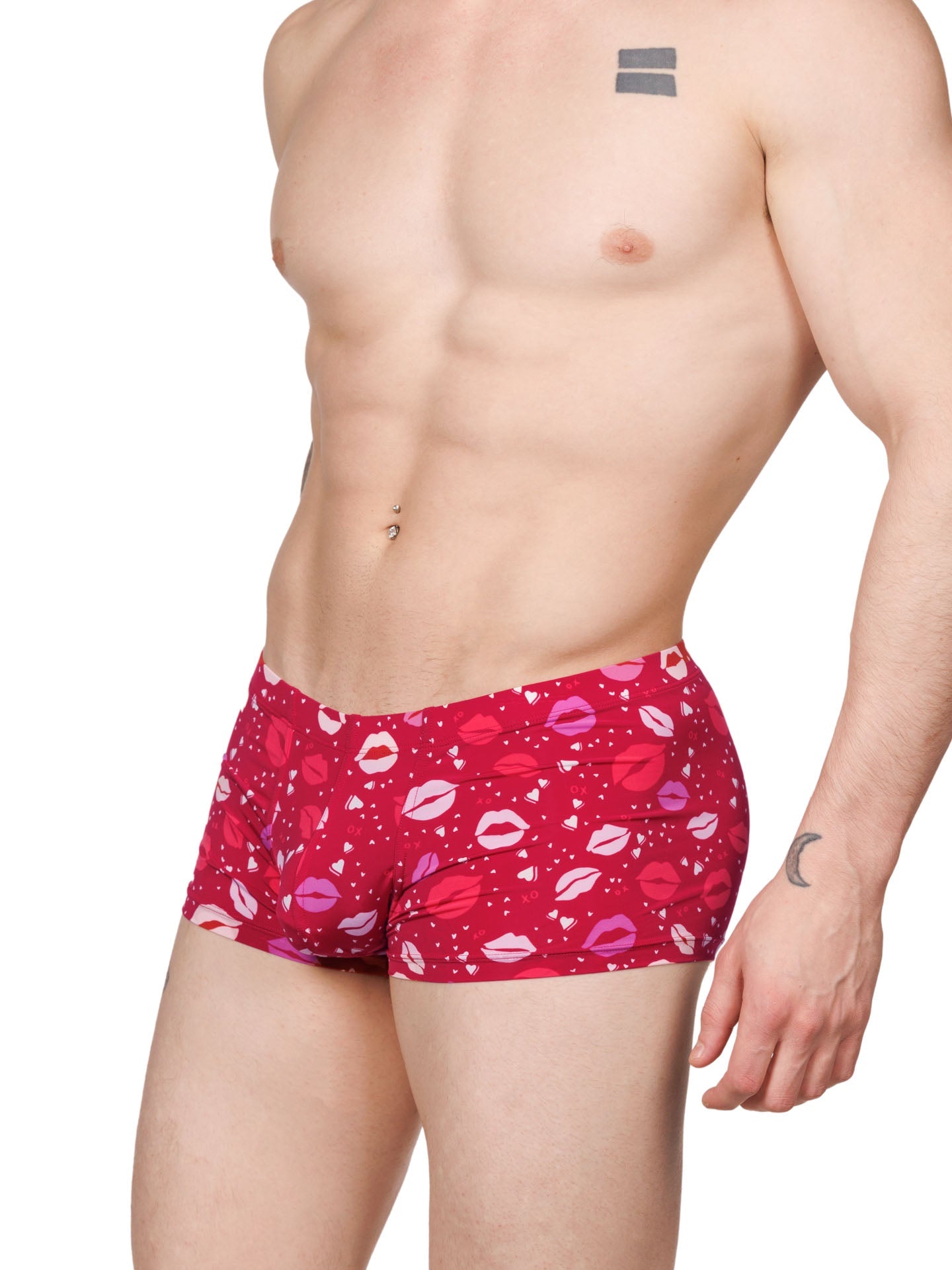 Side view of a male model wearing red XDress boxer shorts with a lipstick kiss pattern