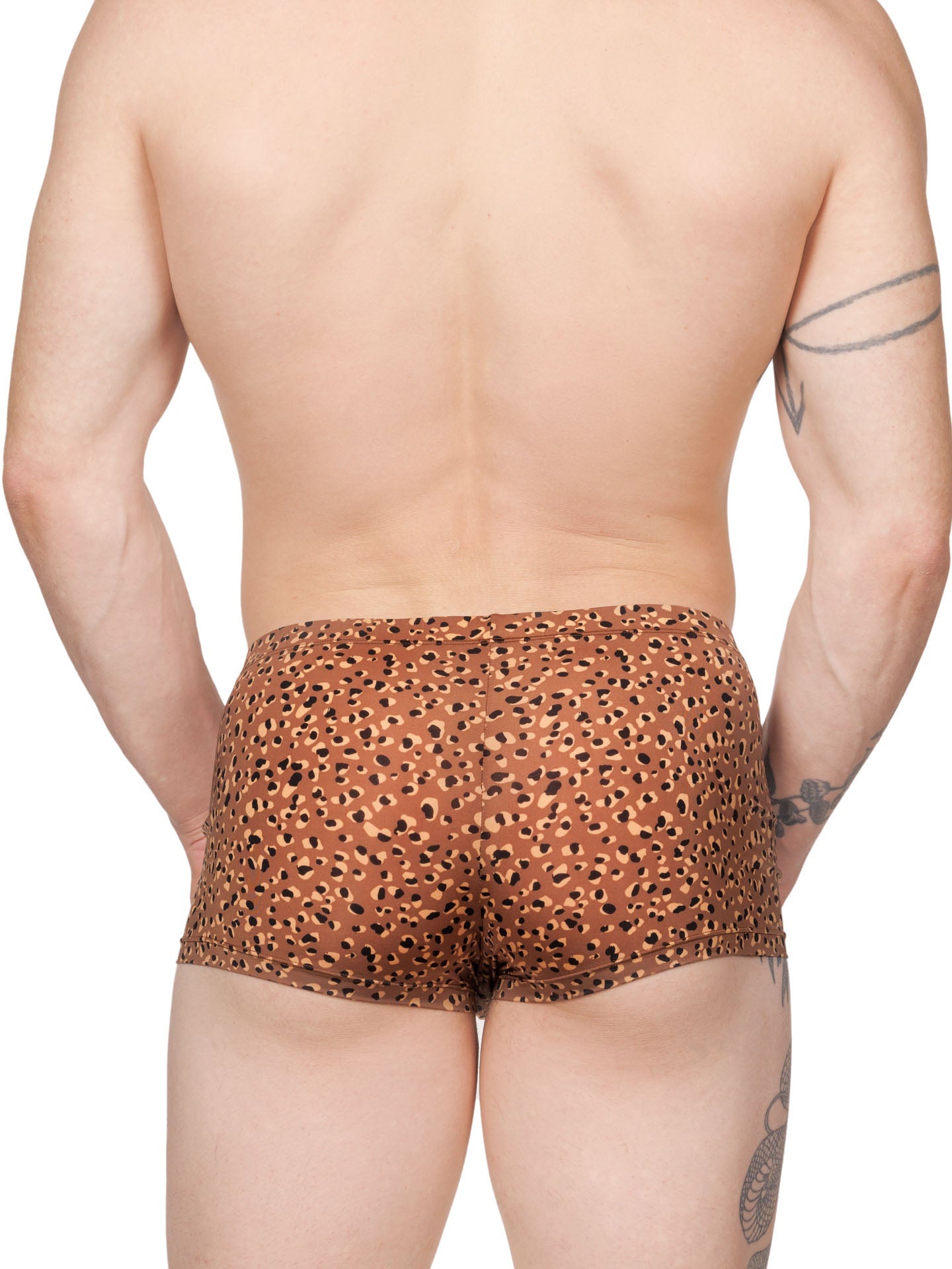 Back view of a male model wearing brown XDress boxer shorts with a leopard spot pattern