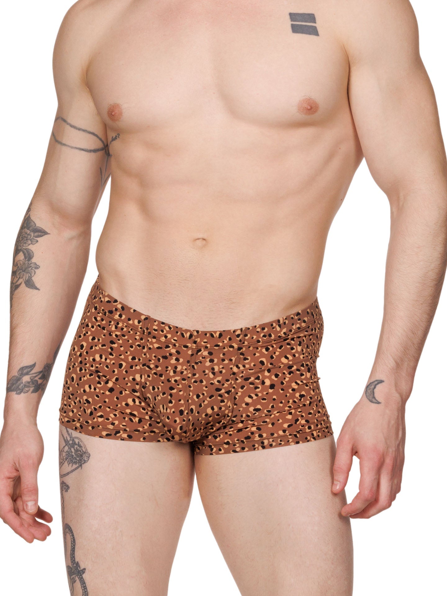 Front view of a male model wearing brown XDress boxer shorts with a leopard spot pattern