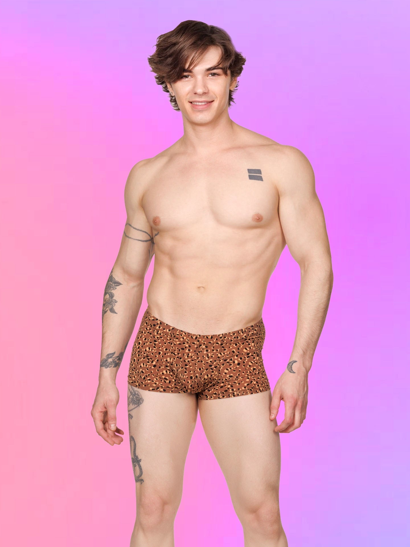 Front view of a male model wearing brown XDress boxer shorts with a leopard spot pattern