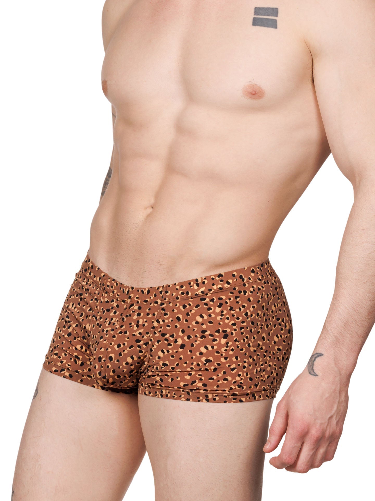 Side view of a male model wearing brown XDress boxer shorts with a leopard spot pattern