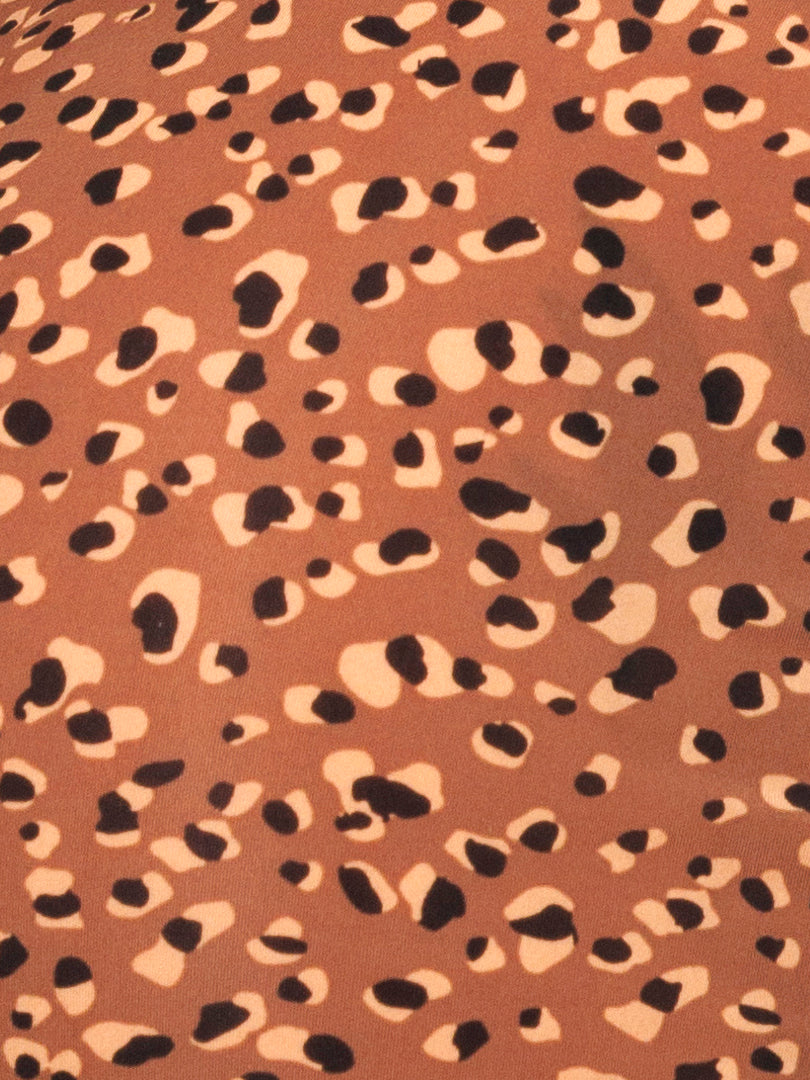 Closeup view of brown fabric with leopard spot pattern