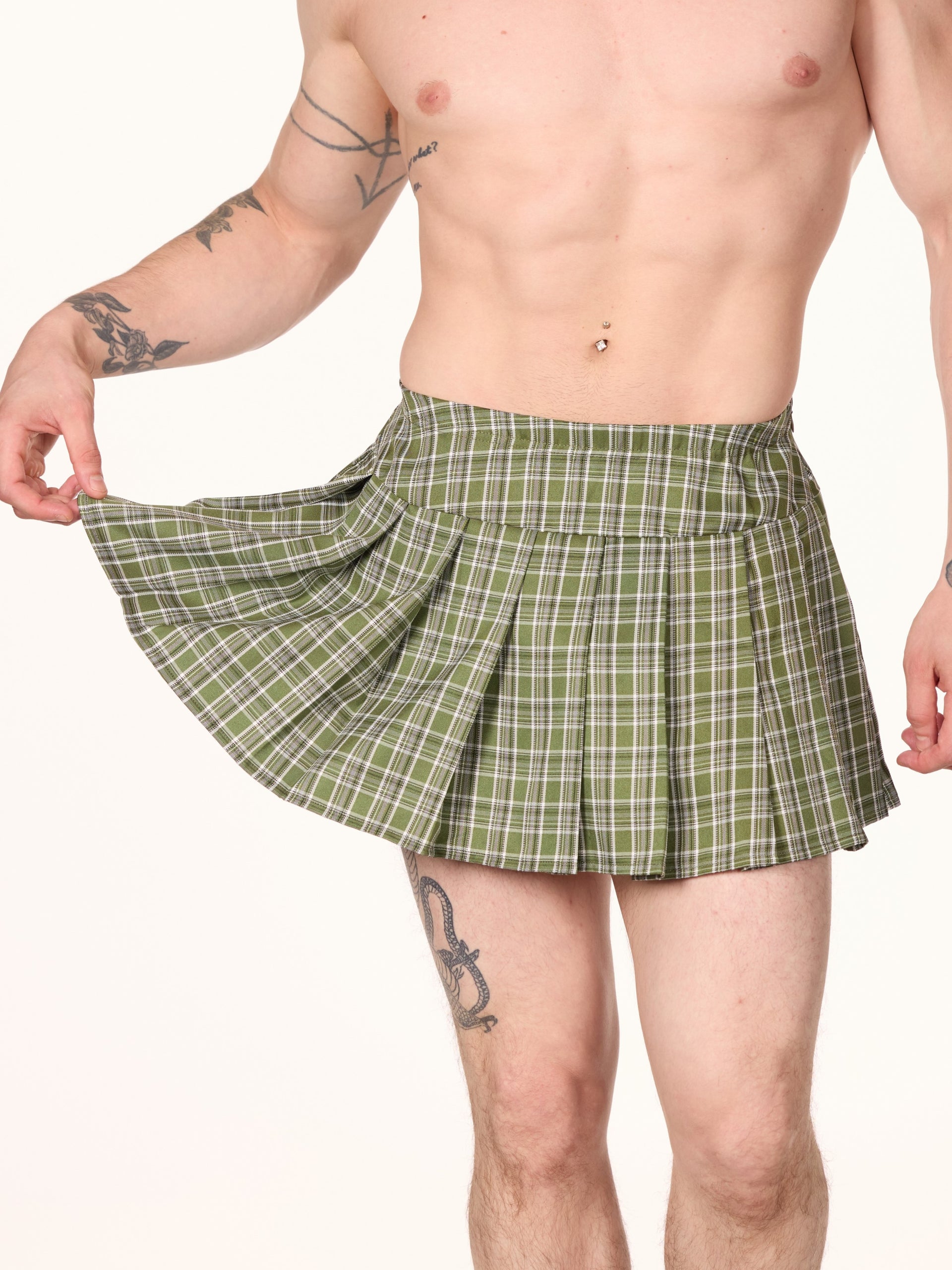 A person wearing a green checkered skirt that reaches knee-length.