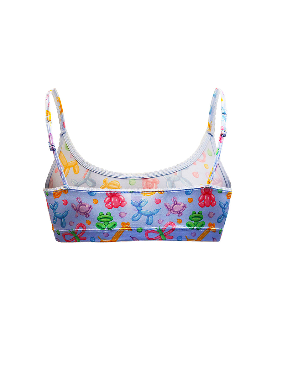 Rear view of a light blue satin bra for men with a colorful balloon animal pattern, on a white background.