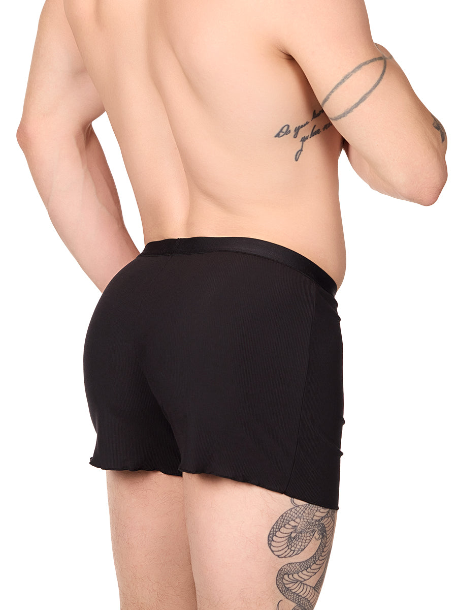 Side view of a man wearing black XDress lounge shorts