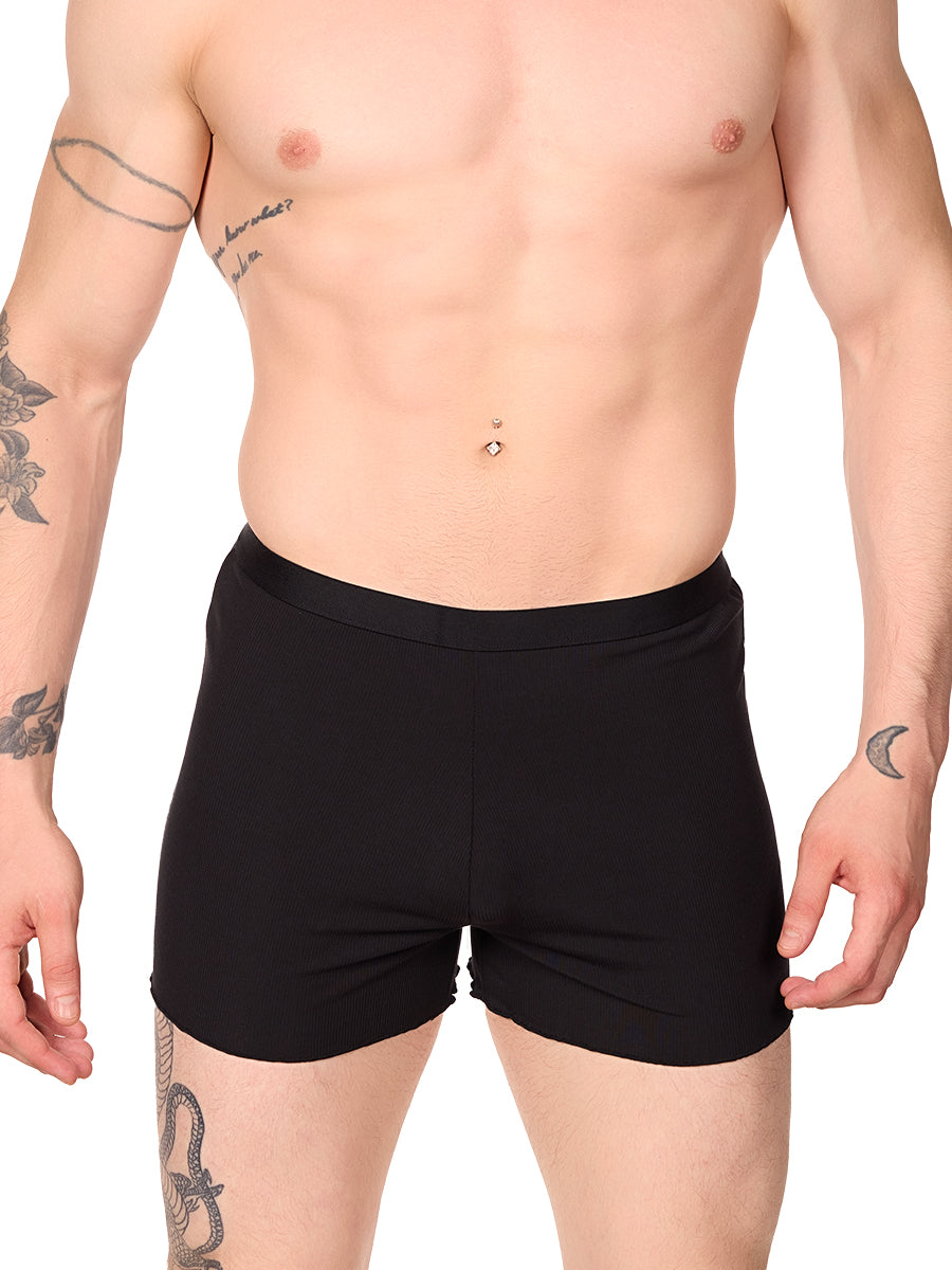 Front view of a man wearing black XDress lounge shorts