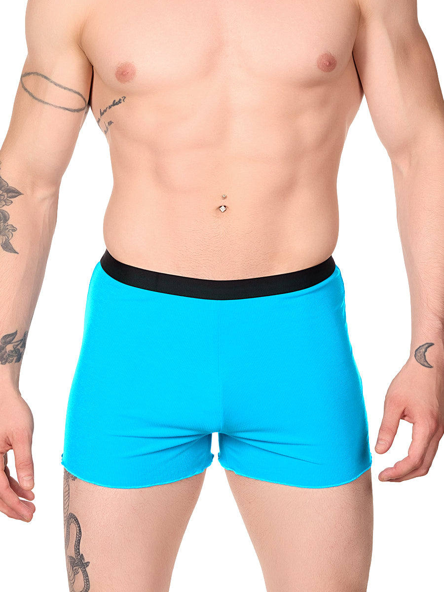 Front view of a man wearing turquoise XDress lounge shorts with black waistband