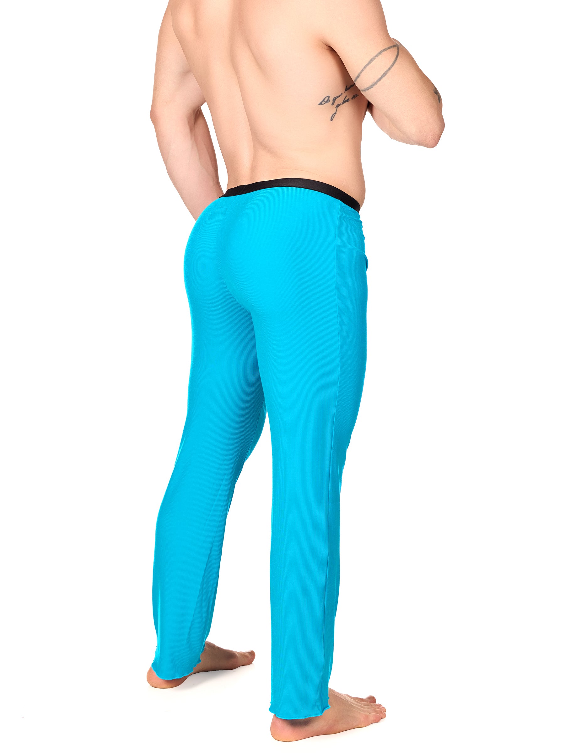 Side view of a man wearing turquoise XDress lounge pants with black waistband