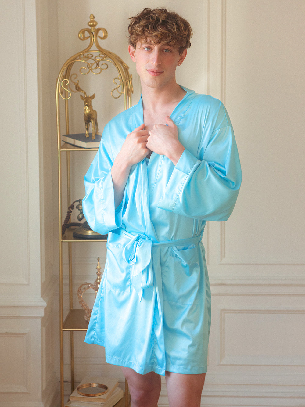 Front view of a male model wearing a light blue XDress robe