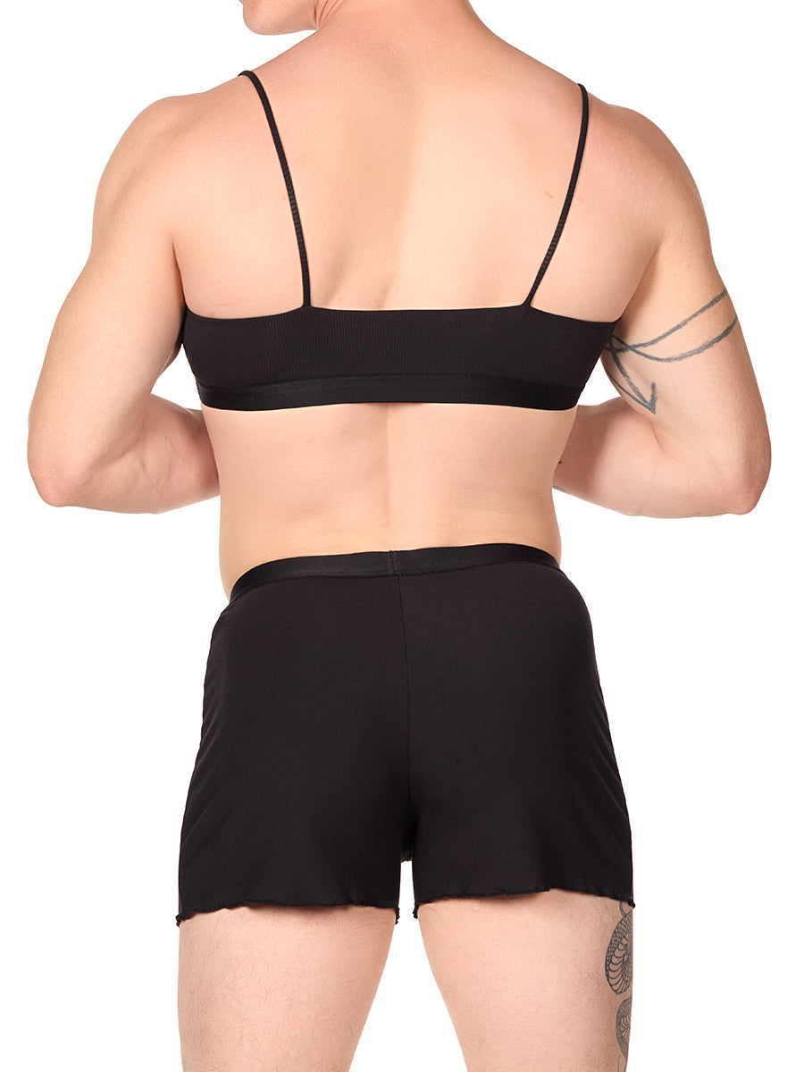 Back view of a man wearing a black XDress bralette with matching shorts