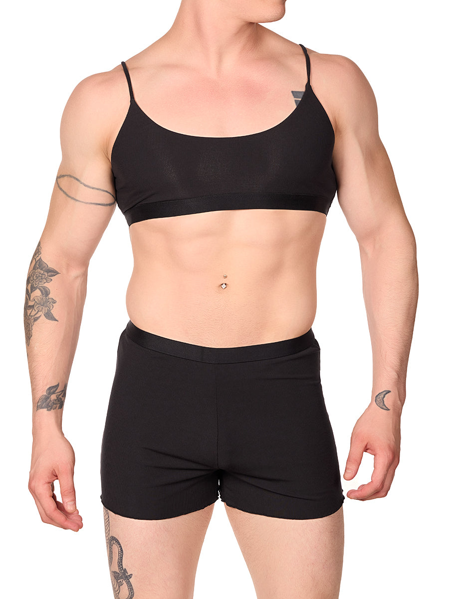 Front view of a man wearing a black XDress bralette with matching shorts