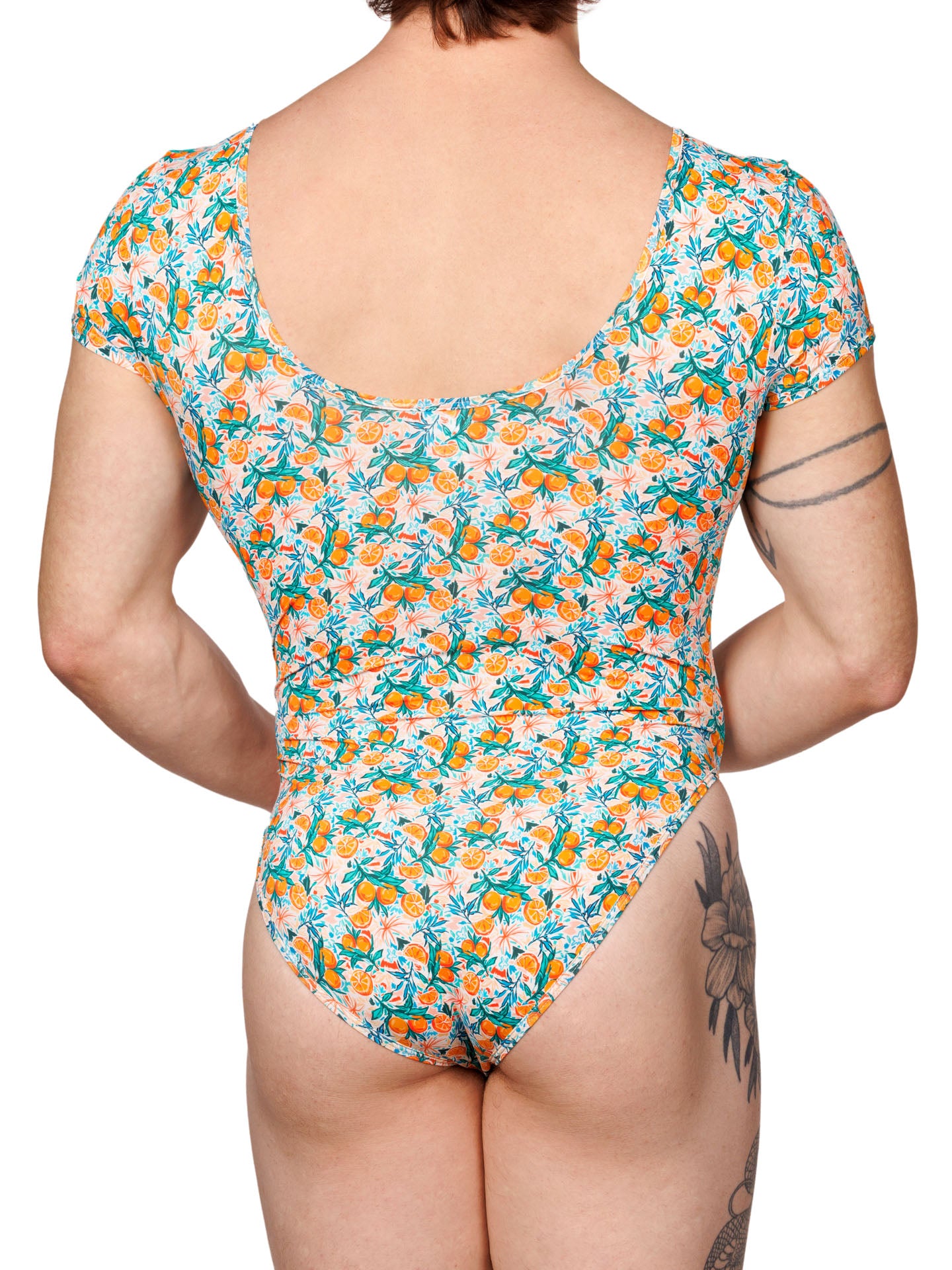 Rear view of a male model wearing an XDress bodysuit with an orange blossom pattern