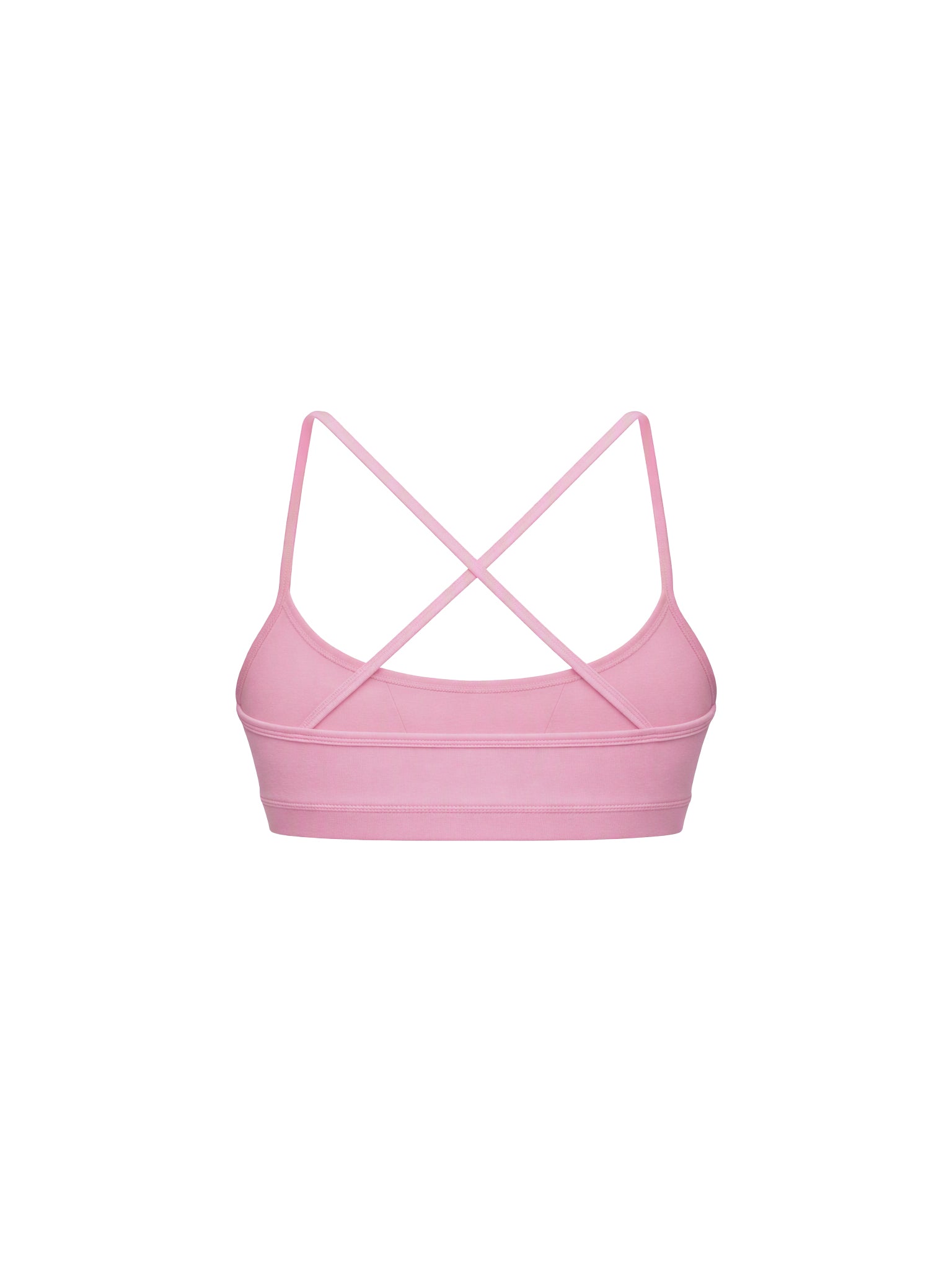 A light pink sports bra with thin crisscrossing shoulder straps, shown from the back on a solid white background.