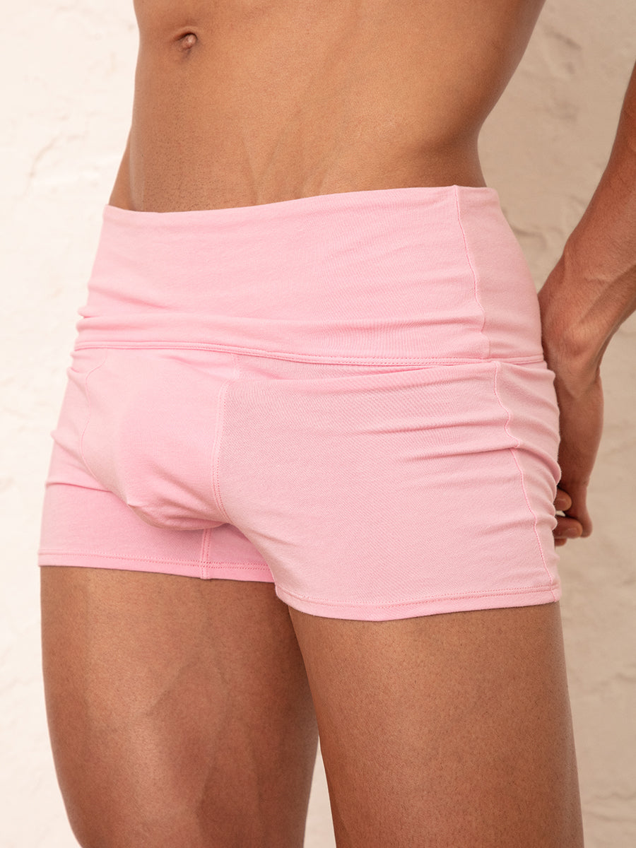 A close-up view of a man wearing pink cotton shorts.