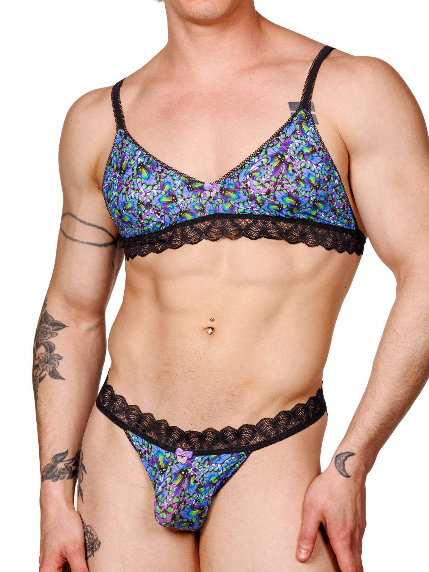 Male model wearing a blue floral print men's bralette with adjustable straps, lace trim, and a matching thong, shown from the front.