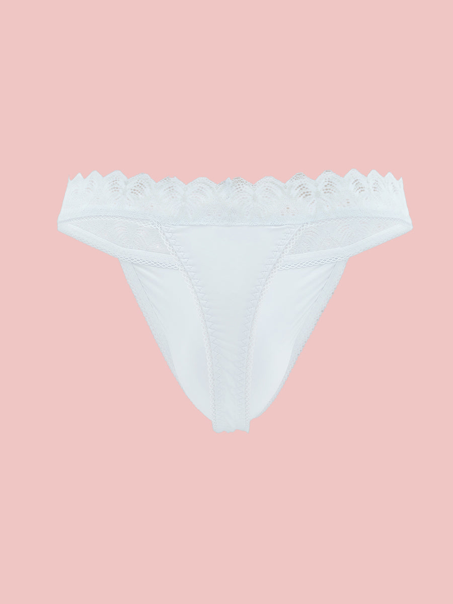 White lace trimmed thong panty on a pink background.