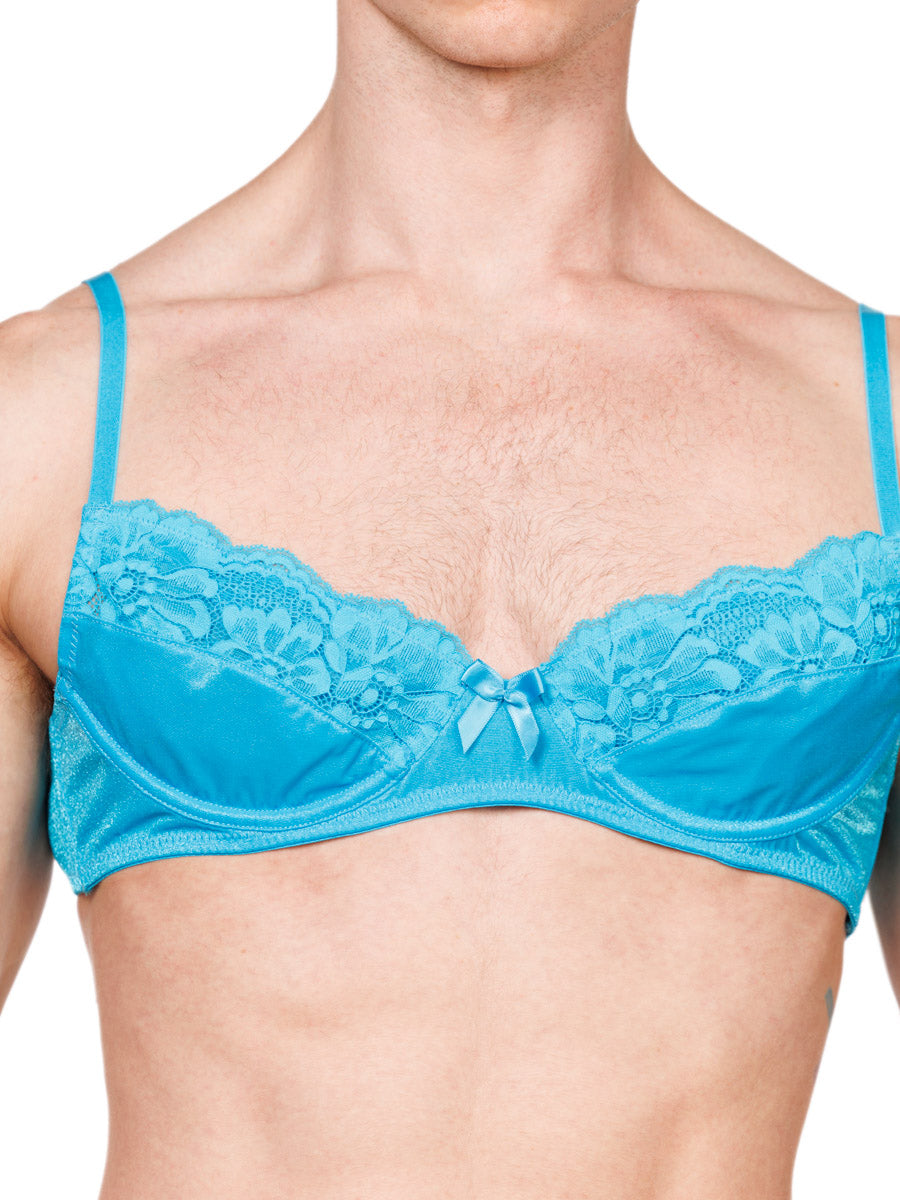 Closeup view of a male model wearing an XDress turquoise bra with lace details