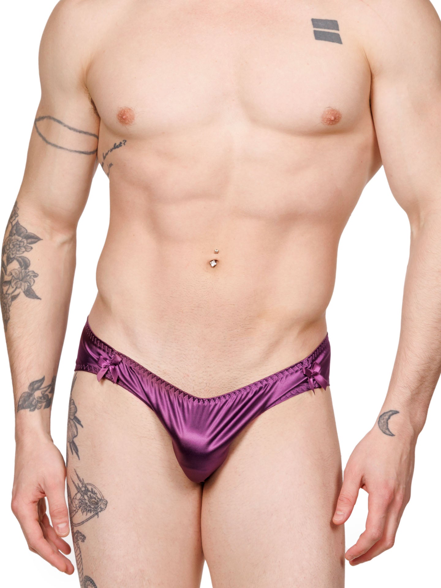 Front view of a male model wearing purple XDress panties with matching bows