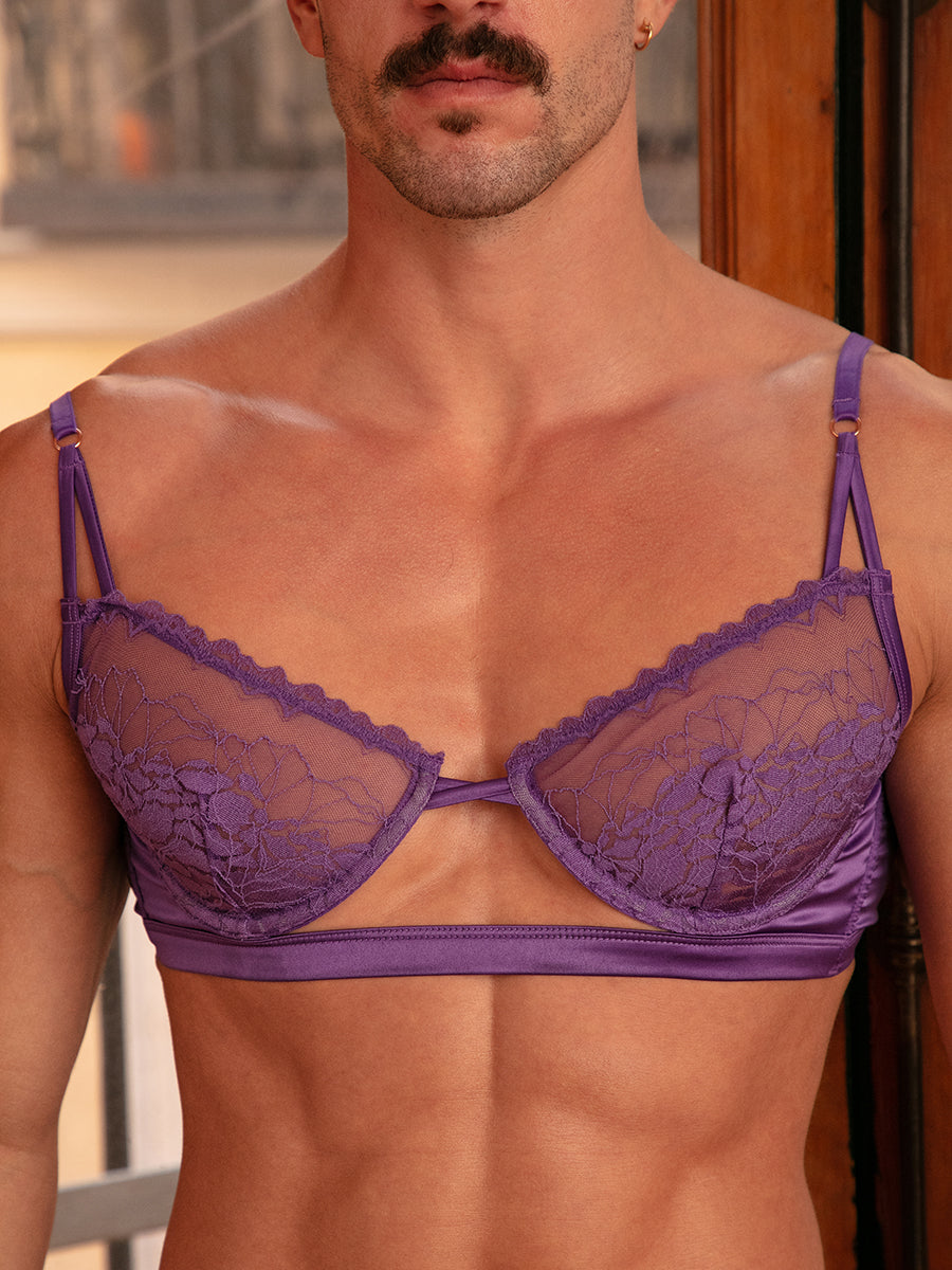 Closeup front view of a man wearing a purple satin and lace bra.