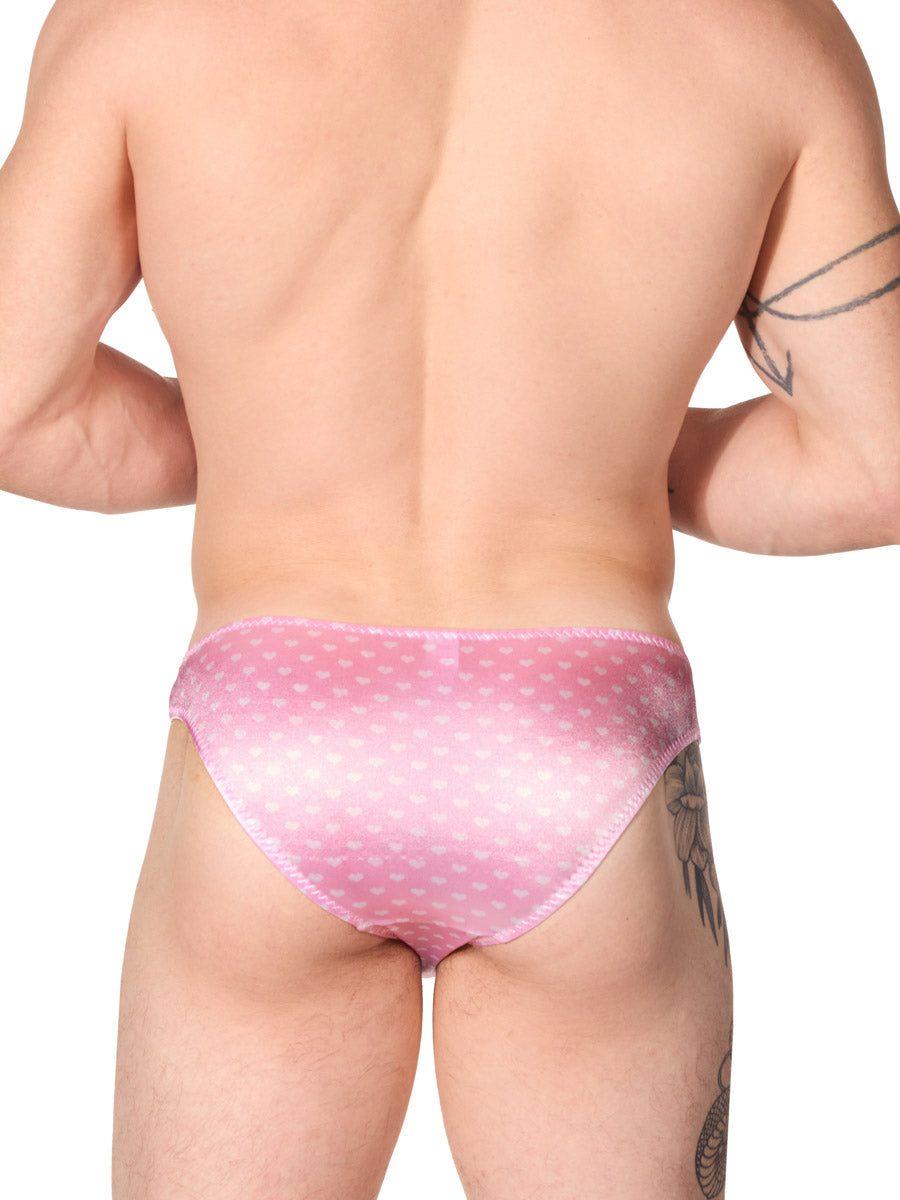 back view of a man wearing light pink XDress satin panties with heart pattern