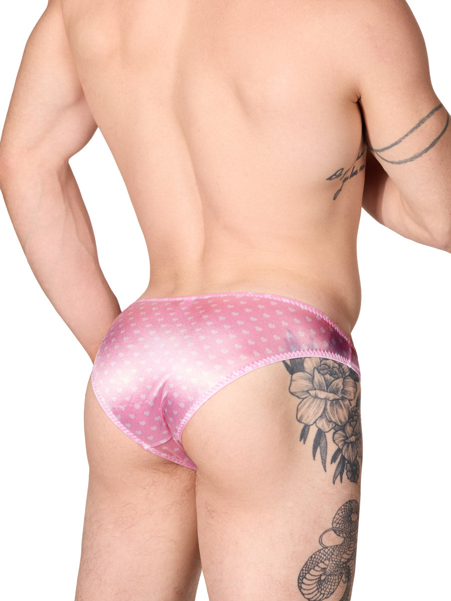 side view of a man wearing light pink XDress satin panties with heart pattern