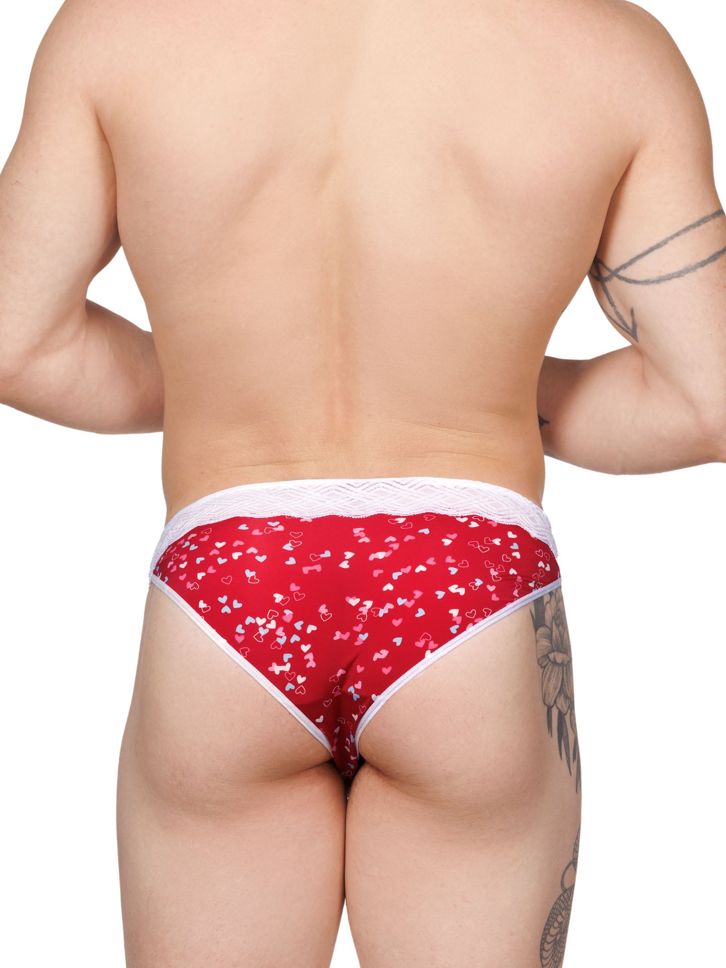 Back view of a male model wearing a red XDress men's panty with colored hearts pattern and lace waistband