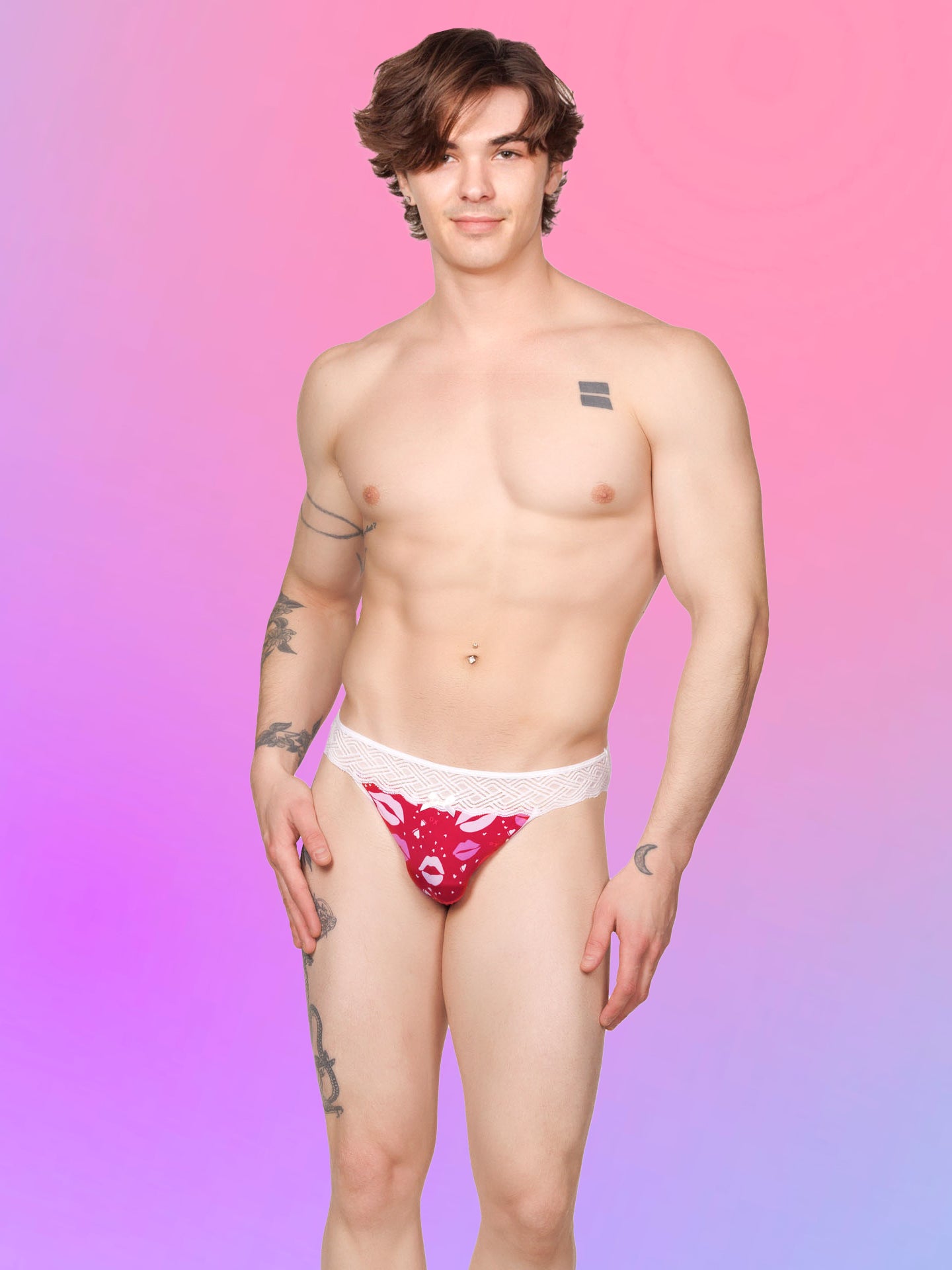 Front view of a male model wearing a red XDress men's panty with lipstick kiss pattern and lace waistband