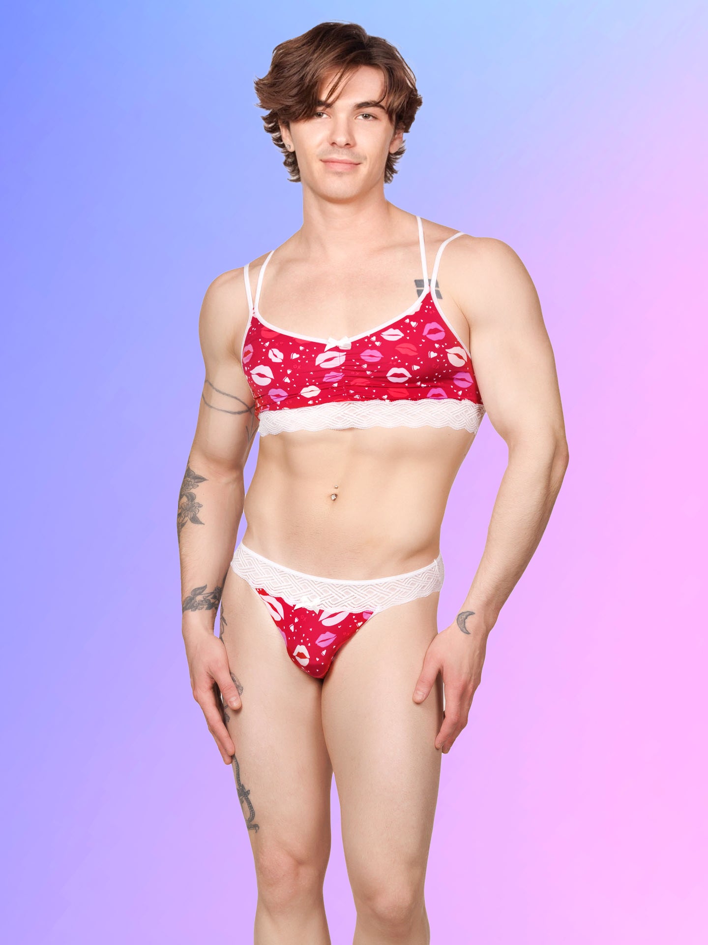 Front view of a male model wearing an XDress matching red and white men's panty and bra with lipstick kisses pattern and lace waistband