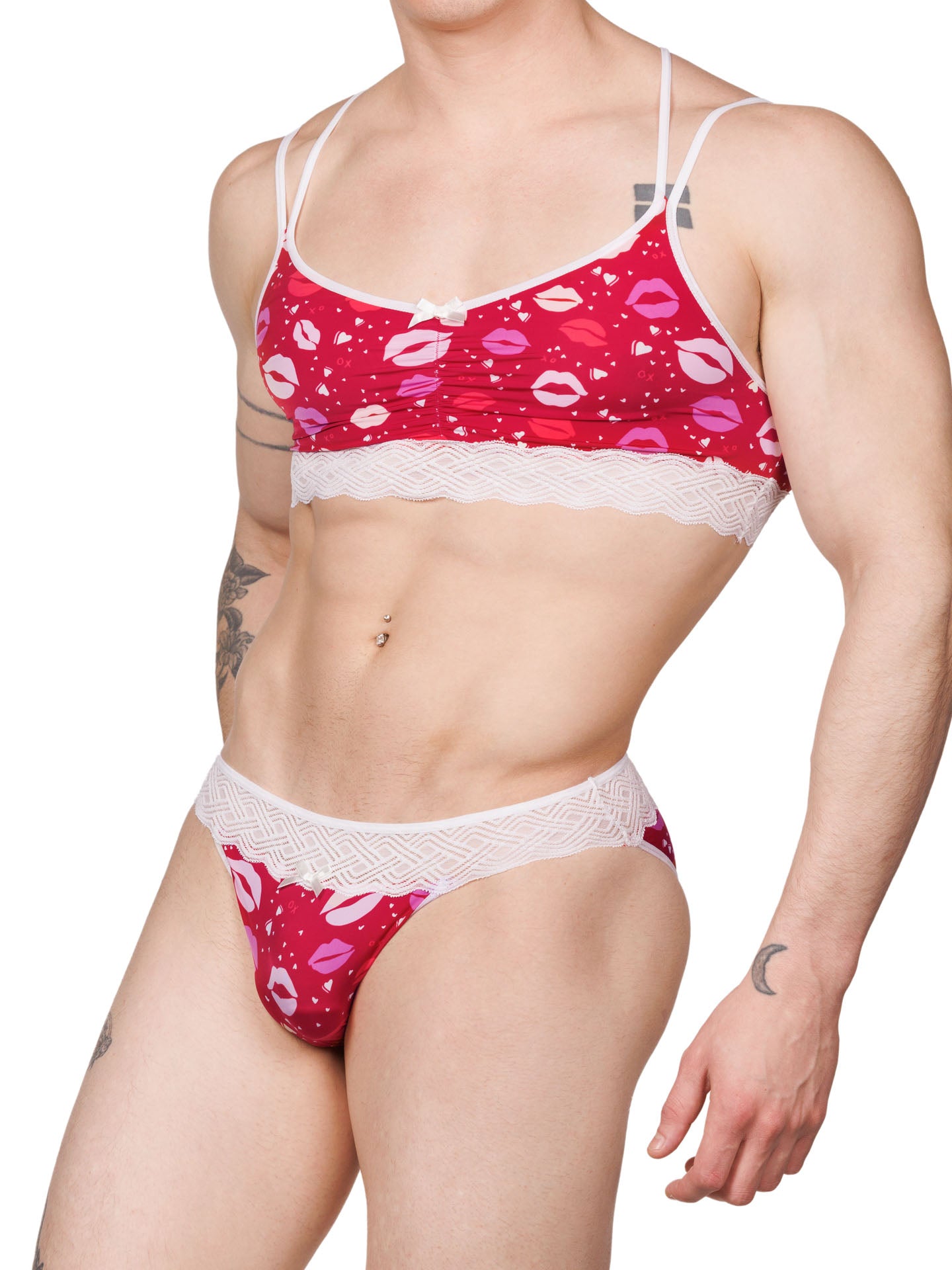 Front view of a male model wearing an XDress matching red and white men's panty and bra with lipstick kisses pattern and lace waistband