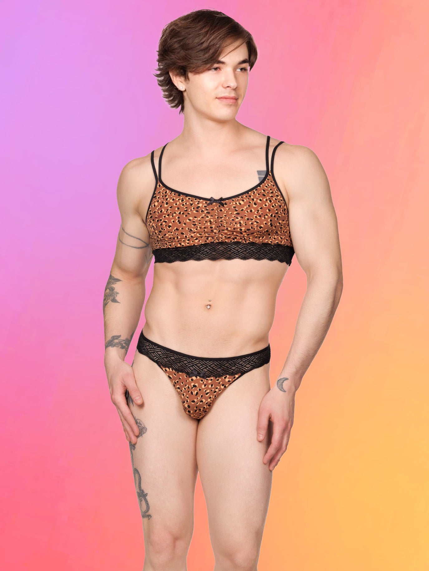 Front view of a male model wearing an XDress lace leopard print bra with matching panties