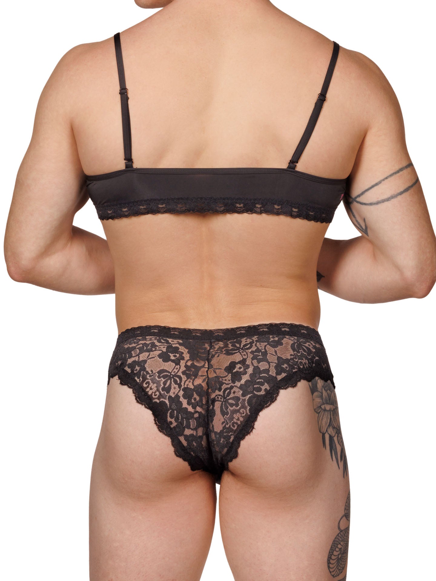 Back view of a male model wearing matching black lace XDress bra and panties