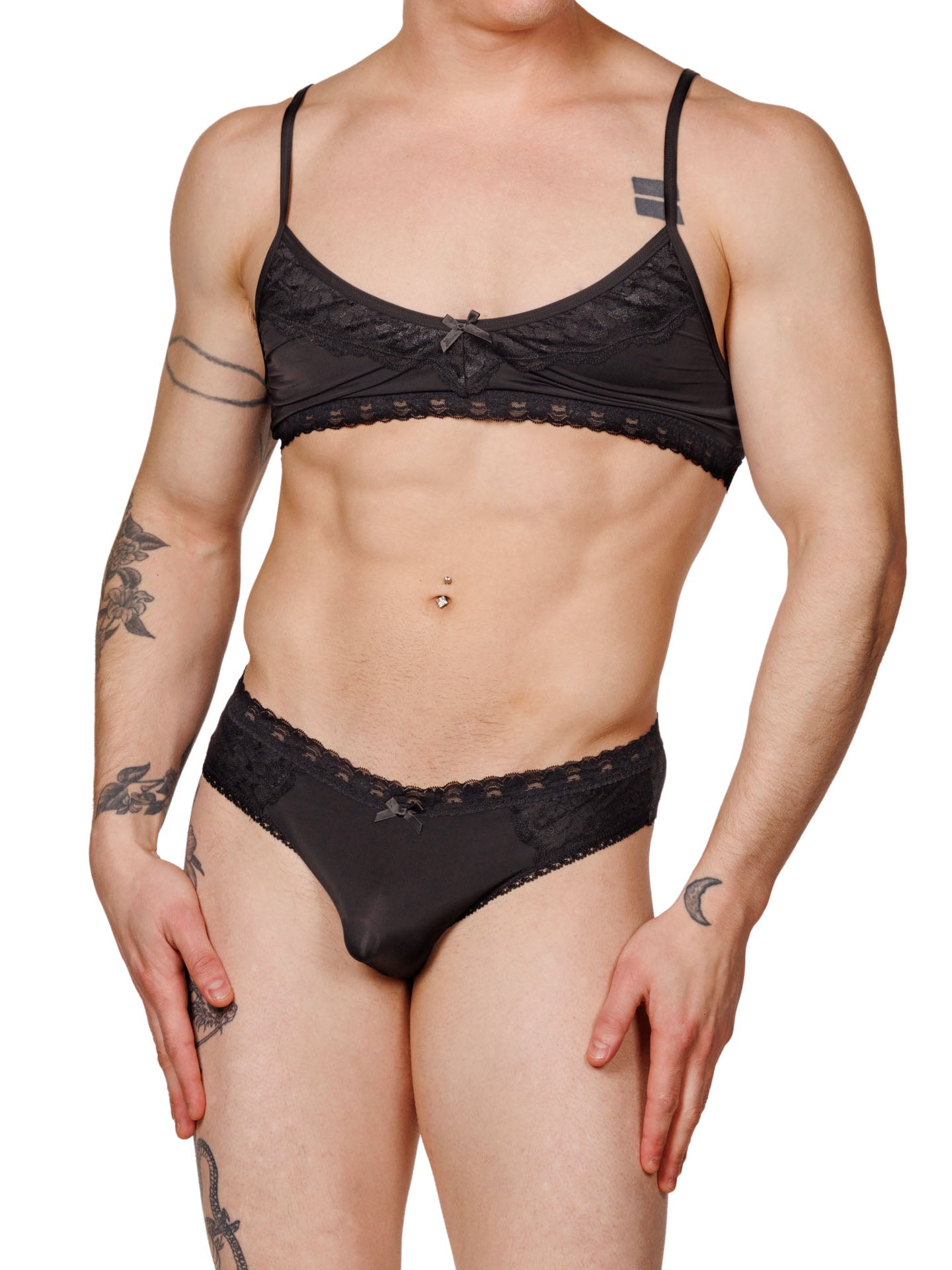 Front view of a male model wearing matching black lace XDress bra and panties