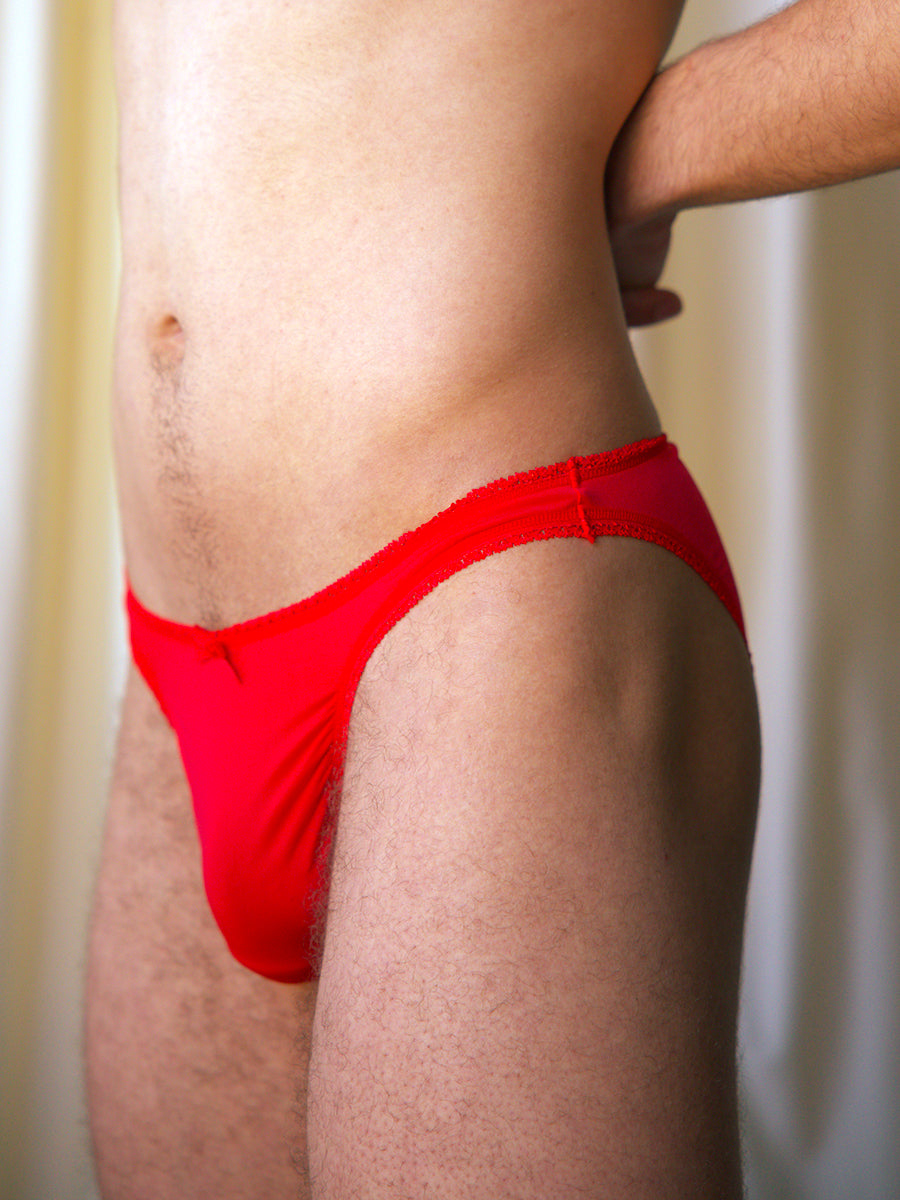 Front view of a male model wearing a red XDress panty