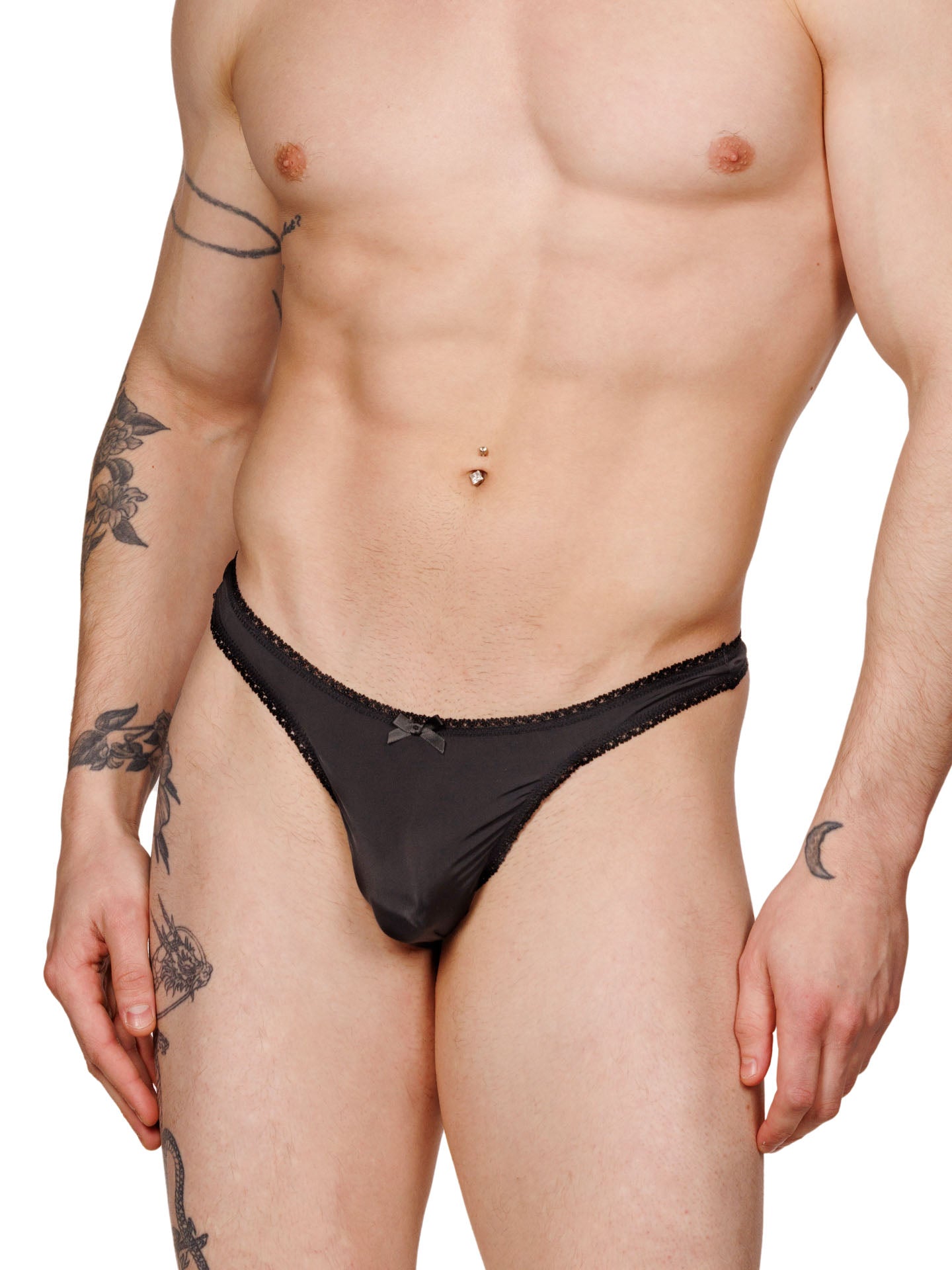 Front view of a male model wearing a black XDress lace thong with satin bow