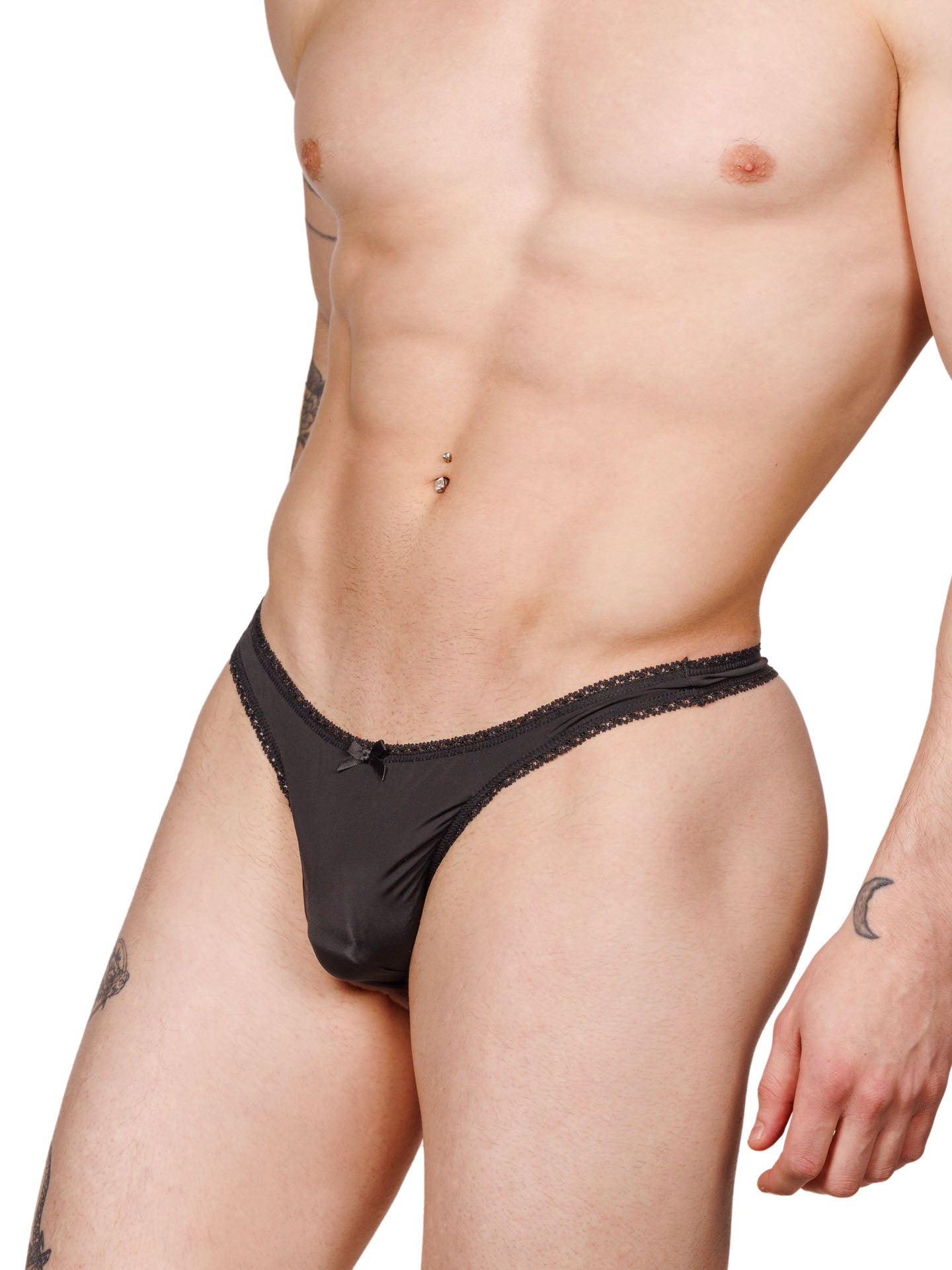 Side view of a male model wearing a black XDress lace thong with satin bow